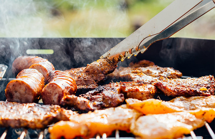 Grilling meat on charcoal grill